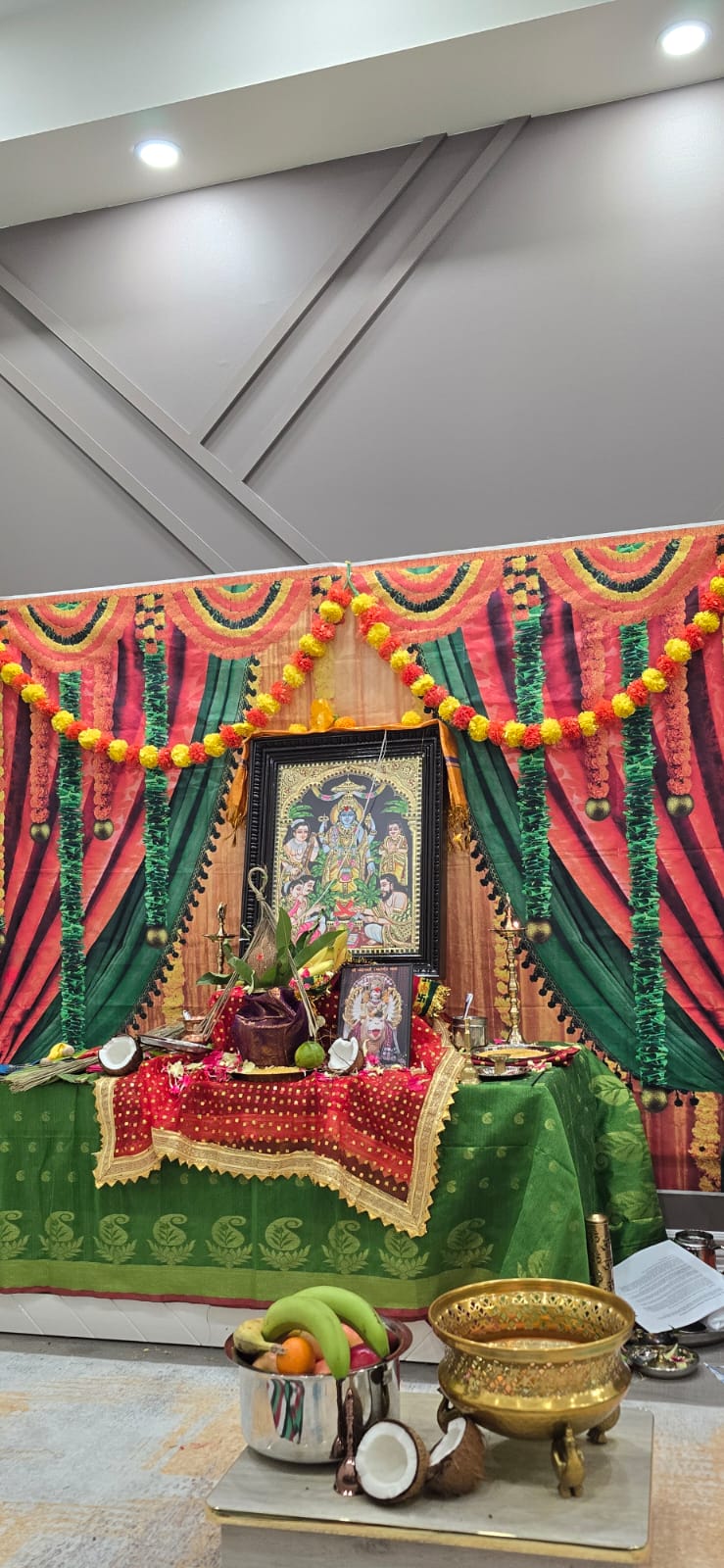 Decorated Satyanarayan Puja altar with marigold garlands, backdrops and offerings
