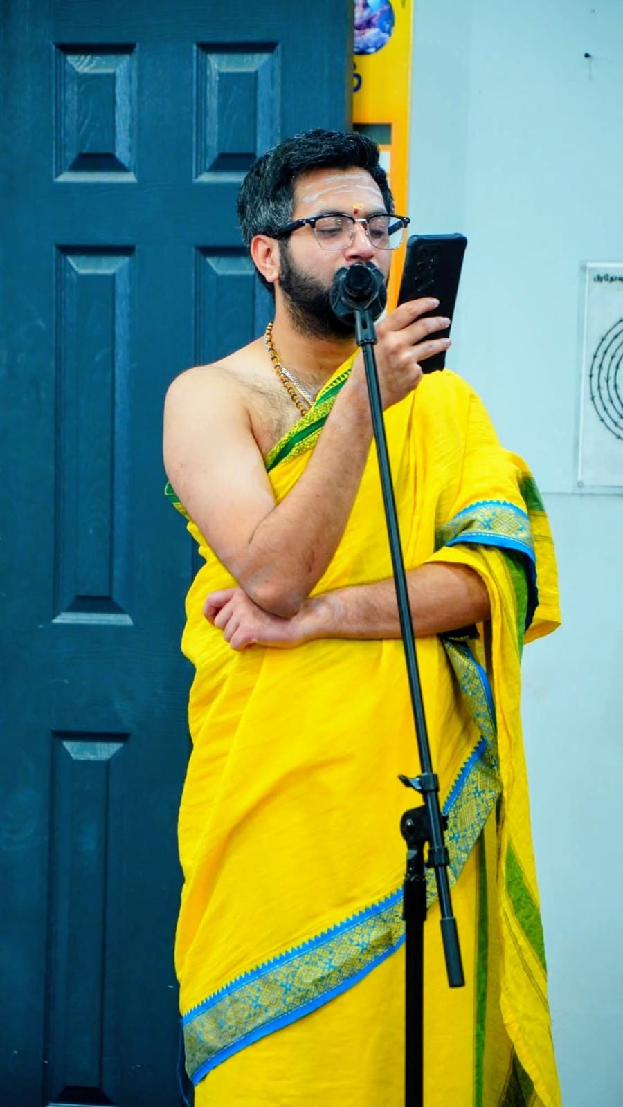 Purohit Surya chanting Vedic mantras at a community puja