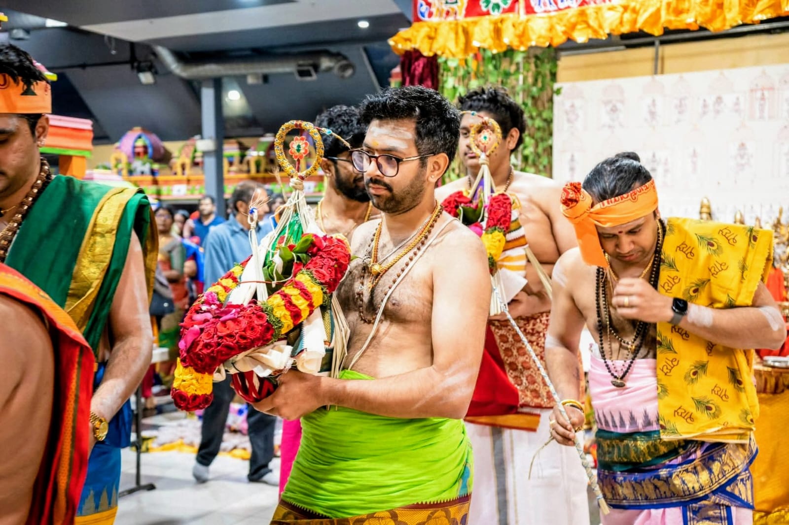 Temple procession with a flower decorated kavadi carried during a festival